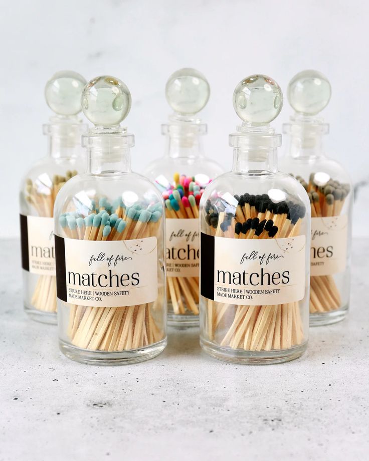 three bottles filled with matches sitting next to each other