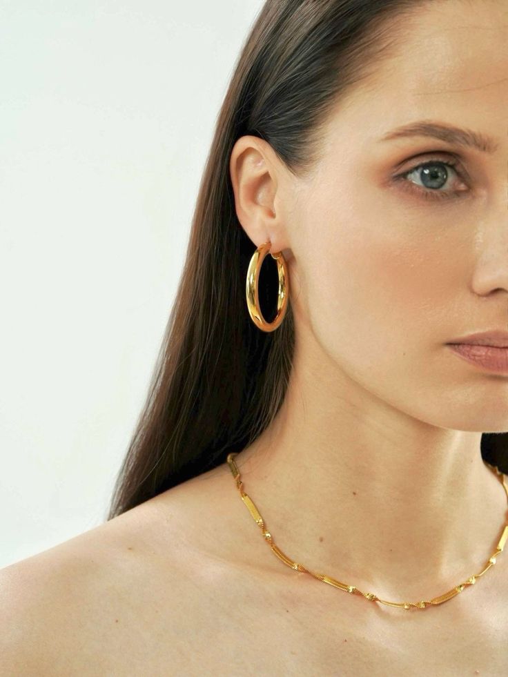 Embrace timeless elegance with our Chunky Gold Hoops. Crafted for those who adore minimalist jewelry, these thick huggie hoops are the quintessential addition to any outfit. Timeless Small Hoop Earrings For Everyday, Timeless Everyday Huggie Hoop Earrings, Tarnish Resistant Everyday Hoop Earrings, Tarnish-resistant Everyday Hoop Earrings, Timeless Hoop Earrings For Everyday Elegance, Timeless Huggie Hoop Earrings For Everyday, Timeless Everyday Hoop Earrings, Everyday Timeless Huggie Hoop Earrings, Chic Everyday Hoop Huggie Earrings