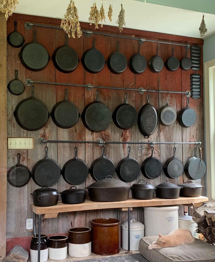 pots and pans are hanging on the wall