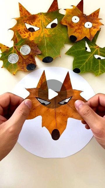 someone is making a paper fox mask out of leaves