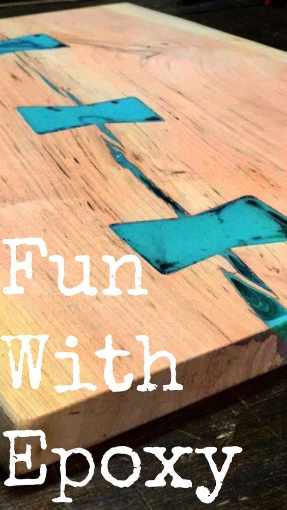 a wooden cutting board with blue tape on it and the words fun with epoxy