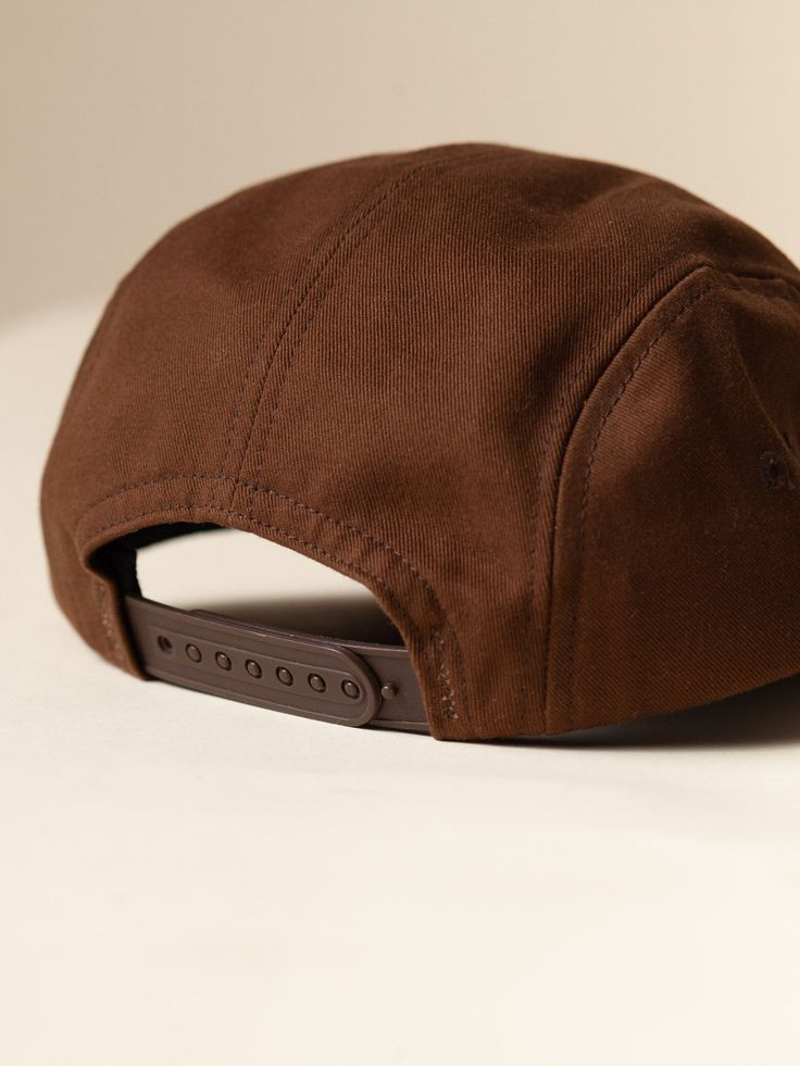 made in USA Our take on a classic snapback. The 5-panel construction is low-profile, not too stiff, and without the uncomfortable leather or metal buckle typical of camper style hats. Heavyweight 100% cotton twill body with breathable nylon mesh inner. Sits just above the ears, comfortable front or back. Made in New Jersey. Brown Fitted Hat With Flat Bill For Streetwear, Brown Flat Bill Fitted Hat For Streetwear, Outdoor Trucker Style Snapback Hat, Brown Flat Bill Baseball Cap For Streetwear, Casual Brown Flat Cap Trucker Hat, Brown Baseball Cap Snapback For Streetwear, Brown Snapback Baseball Cap For Streetwear, Adjustable Cotton Trucker Snapback Hat, Adjustable Trucker Snapback Hat In Cotton