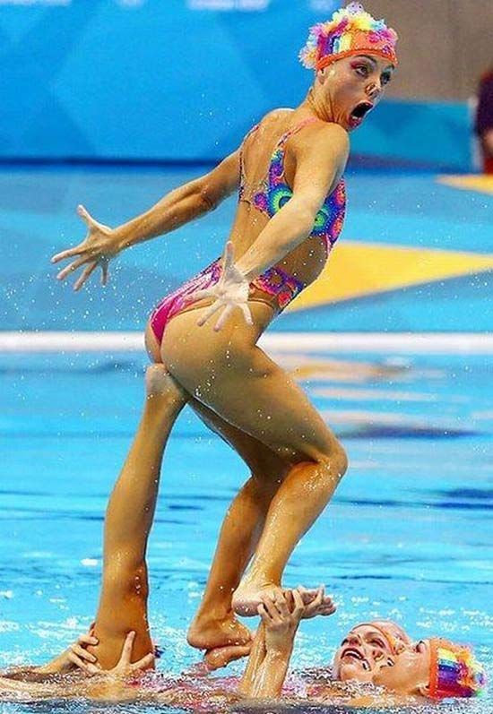 a woman standing on top of a swimming pool next to another person in the water