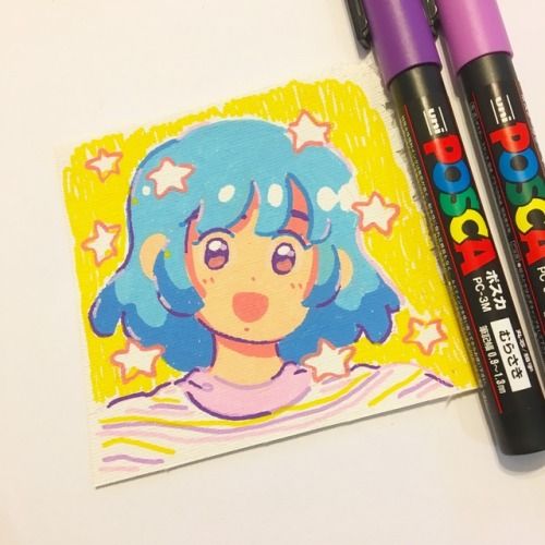 two crayon markers next to a drawing of a girl with blue hair