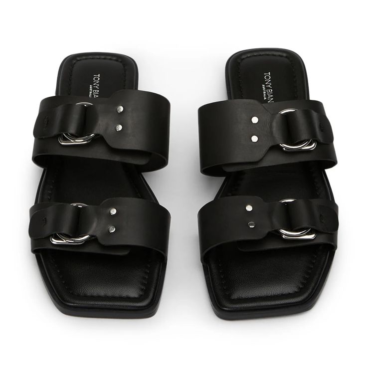 Tony Bianco Rory Flat Sandals Size Eu 40 / Us 9.5 Seller Notes: Brand New In Box Unworn Tony Bianco Description: Intended For Summer Time Adventures Or A Day Full Of Errands, Rory Is The Slide You've Been Missing. Crafted From Our Signatory Black Leather, This Style Features Two Upper Straps With Buckle Look Detail. -Material: Leather -Sole: Leather -Fit: True To Size -Toe-Shape: Open -Features: Gold Hardware (Looks Silver As Pictured) -Heel: 1cm Black Slip-on Sandals With Tang Buckle, Thigh High Boots Flat, Black Sandals Flat, White High Heels, Embellished Heels, High Heel Mules, Metallic Shoes, Bridal Heels, Tony Bianco