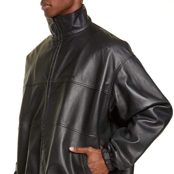 Balenciaga Doesn't Do Anything By Half Measures, It's Always Oversized. This Black Lambskin Panelled Bomber Jacket Is A Prime Example And Its Silhouette Can Be Manipulated With The Drawstring Hem And A Belt Around The Waist. Featuring A Stand-Up Collar, A Front Zip Fastening, An Embroidered Logo To The Front, Long Sleeves, Elasticated Cuffs And A Drawstring Hem. Designer Leather Jacket For Spring Streetwear, Designer Oversized Black Outerwear, Designer Black Oversized Outerwear, Black Designer Oversized Outerwear, Luxury Spring Outerwear For Streetwear, Luxury Spring Streetwear Outerwear, Balenciaga Jacket, Balenciaga Men, Painting Leather