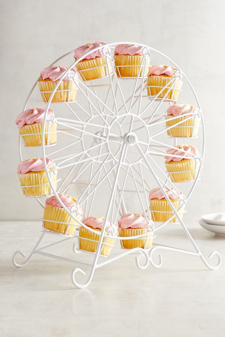 cupcakes are arranged in front of a ferris wheel