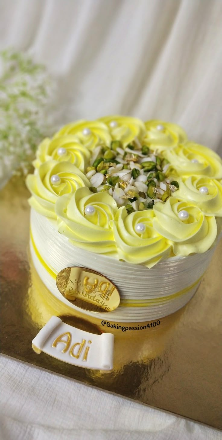 a yellow and white cake with flowers on it