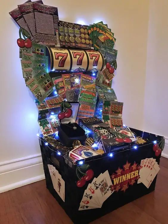 a casino machine with lots of cards and lights on it's sides, sitting in a room