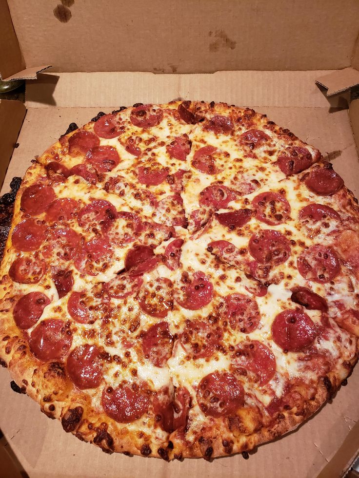 a large pepperoni pizza in a box