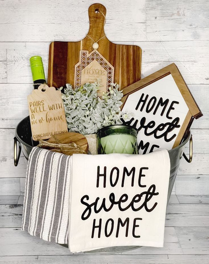 the home sweet home gift basket is filled with fresh flowers and kitchen accessories, along with personalized tea towels