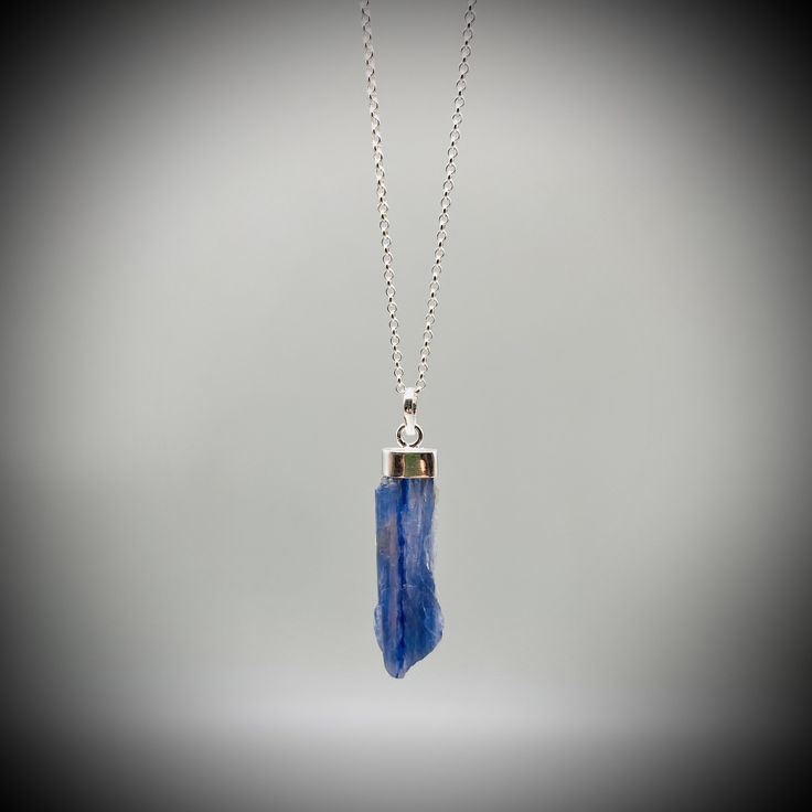 Blue Kyanite Crystal Point  and Sterling Silver Pendant on your choice of with a  16 or 18 inch sterling silver belcher chain. This is a beautiful Kyanite crystal blade, approximately 3.5cm x 1cm Our jewellery always comes beautifully gift boxed and bagged with a crystal meaning card.  BLUE KYANITE BENEFITS Aids with healing of the throat Strengthens the voice and gives confidence Creates Soothing and harmonic energy Encourages self-expression and communication All of our crystal are ethically sourced and are treated with love, care and respect. Blue Kyanite Gemstone Necklace, Blue Kyanite Necklace For Gift, Blue Sodalite Pendant Necklace, Blue Gemstone Crystal Necklace As A Gift, Blue Nickel-free Crystal Necklace As Gift, Blue Birthstone Jewelry For Healing, Blue Sterling Silver Necklace For Gift, Sodalite Pendant Necklace For Gift, Sapphire Kyanite Gemstone Necklace