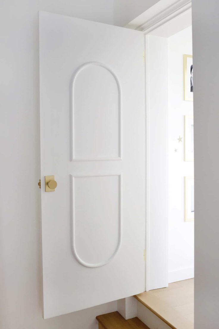 an open door with a white handle on the front and side of it in a room