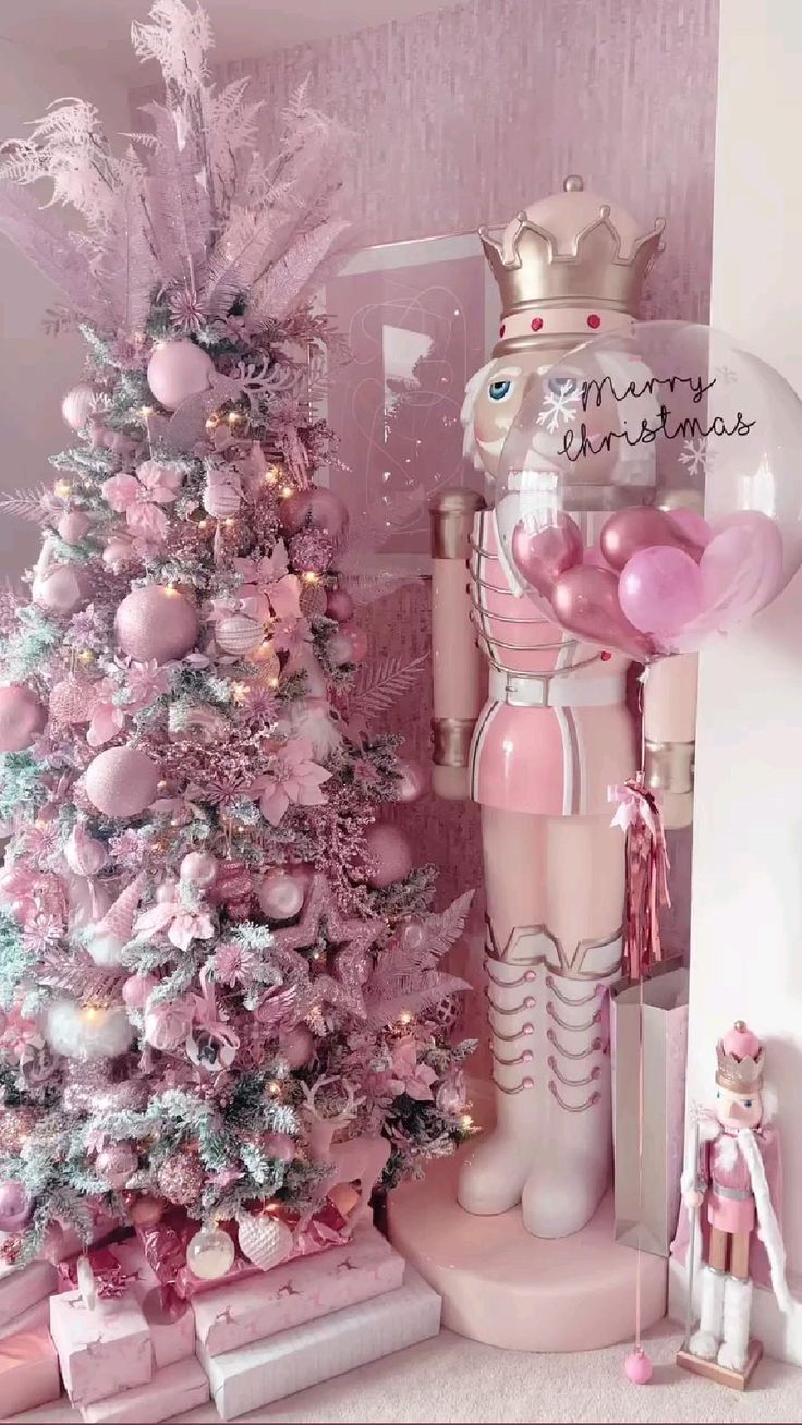 a pink christmas tree decorated with balloons and decorations