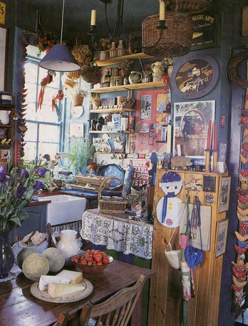 a kitchen filled with lots of clutter and decor on top of a wooden table