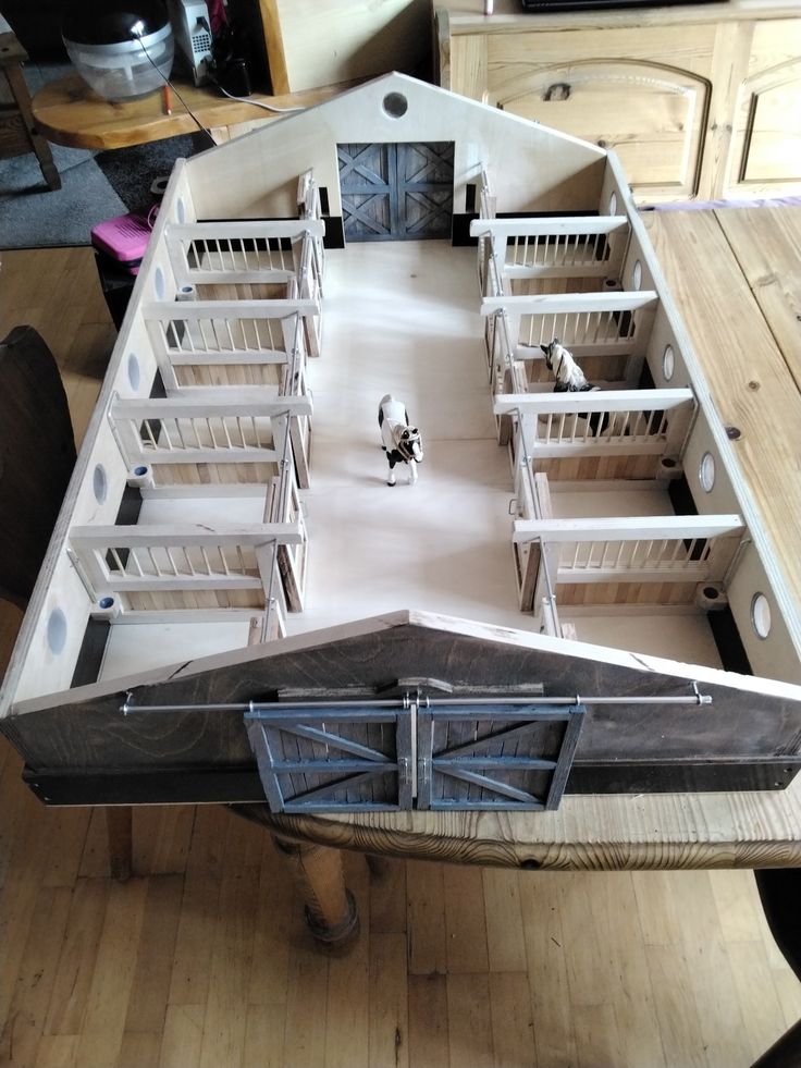 a model boat sitting on top of a wooden table