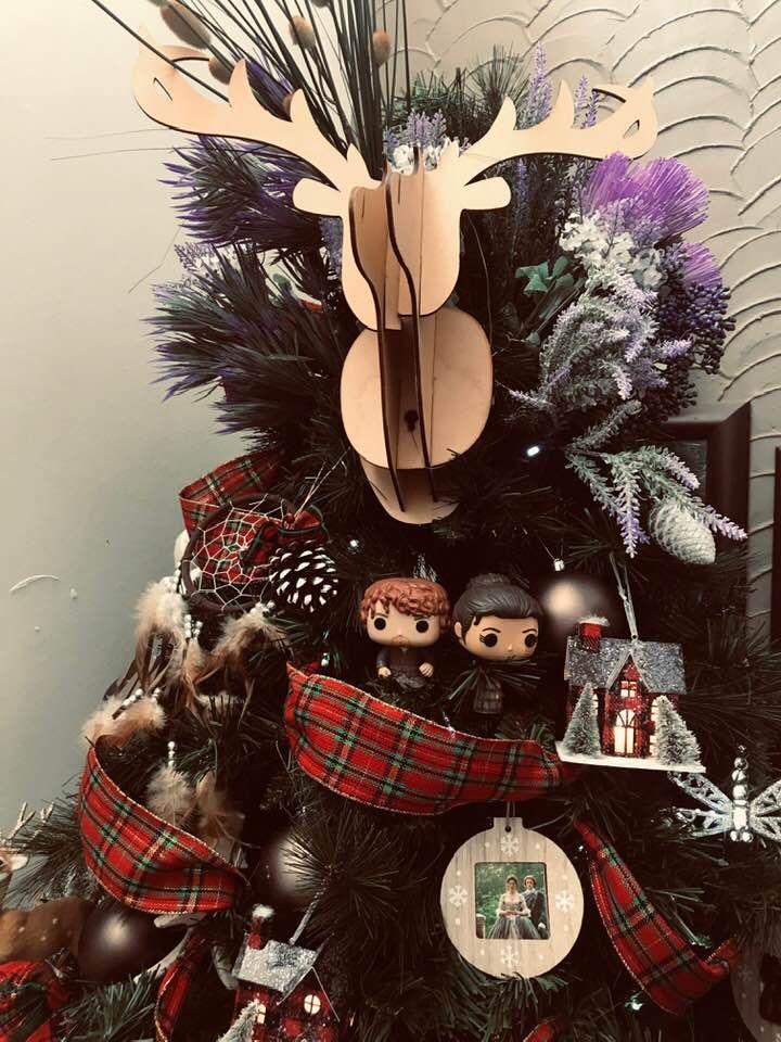 a christmas tree decorated with ornaments and deer heads