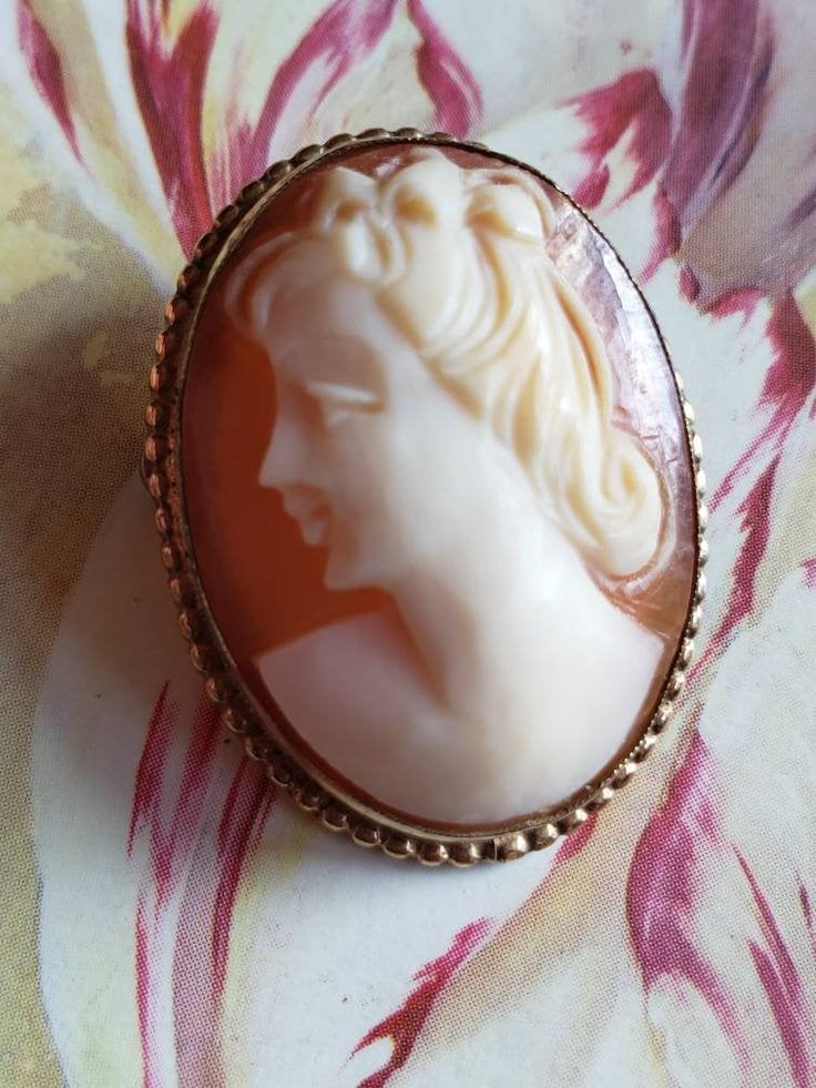 This is a vintage AMCO cameo brooch/pendant. It is oval and is stamped 1/20 14 K GF. The cameo measures just over .75 x a bit over 1 inch. Don't forget to stop in at my other Etsy shop... http://www.etsy.com/shop/xtdesigns. Follow me on Twitter at... MyYiayiaHadThat@MyYiayiaHadThat. If you have a wish list or are looking for something specific, please ask. I may have exactly what you are looking for. As always please convo me with any questions or concerns regarding this item or with any interna White Profile, Cameo Brooch, Purple Velvet, Wish List, Brooch Pin, Brooches, 1 Inch, Gold Filled, Don't Forget