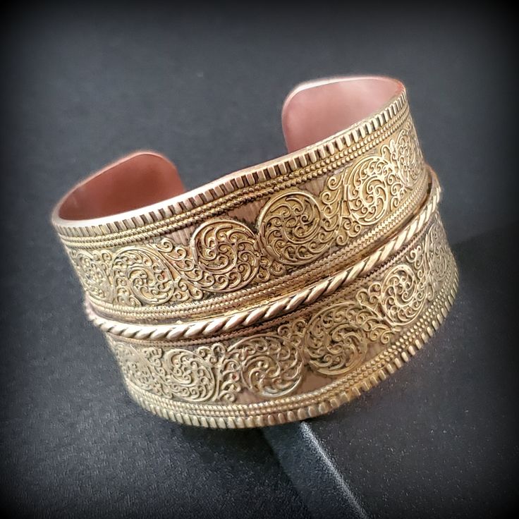 Vintage wide brass bracelet, chunky bracelet, Wide open wrist bangle bracelet, Handmade Copper & Brass Bracelet Ethnic Geometric Design Metal -  bronze outside, copper inside Stone -   Size - 6 3/4'' , wide '' Mark -  Circa  before the 2000s  Condition - good condition.  PLEASE NOTE: Vintage jewelry can show signs of wear and discoloration or chipped metal consistent with age. Please look at the pictures carefully. Most were purchased at estate sales, auctions, etc. so they could need cleaning. Bohemian Wide Band Engraved Jewelry, Bohemian Gold Engraved Bracelets, Bohemian Gold Engraved Bracelet, Festival Brass Bangle Cuff Bracelet, Festival Brass Cuff Bangle Bracelet, Bohemian Cuff Bracelet For Festivals With Intricate Design, Bohemian Cuff Bracelet With Intricate Design For Festivals, Bohemian Antique Gold Bracelets For Gift, Bohemian Wide Band Adjustable Bracelets