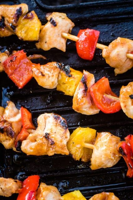 chicken and vegetable kabobs are being cooked on the grill