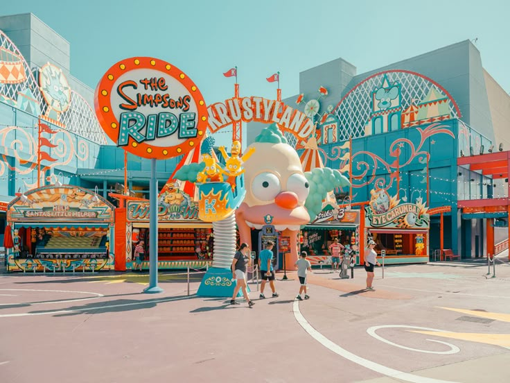 an amusement park with people walking around it