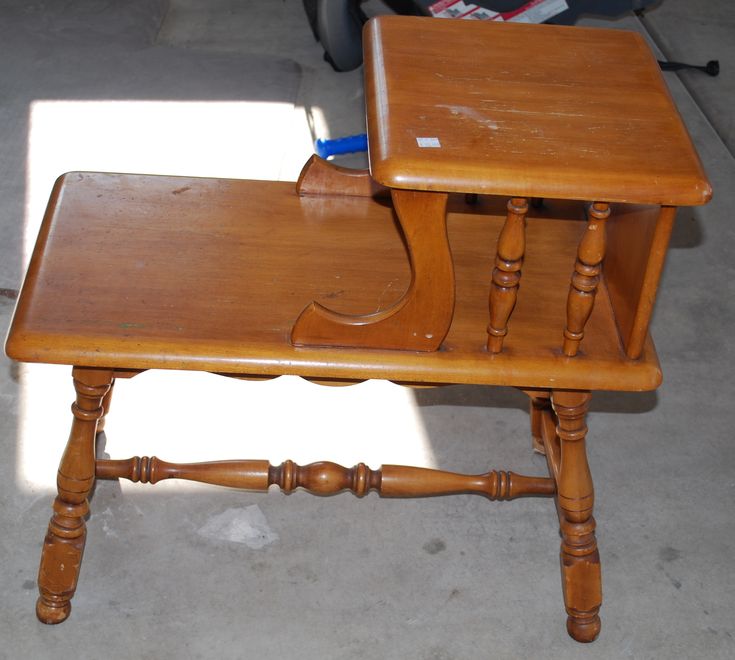 a small wooden table sitting on the ground