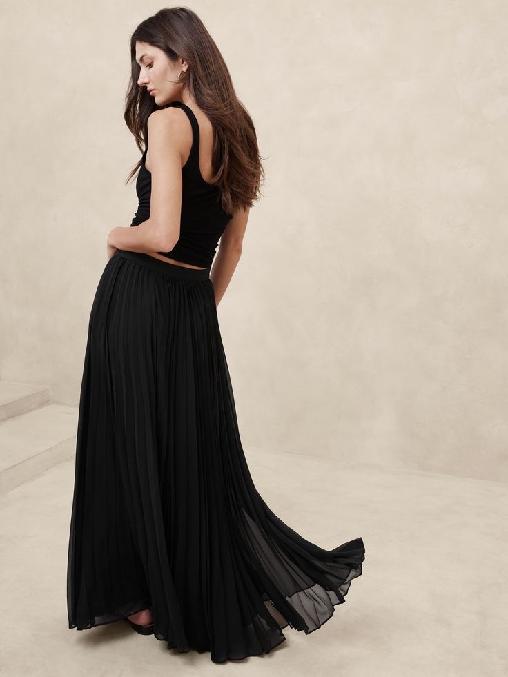 We opted for a luxurious pleated construction to showcase the beautiful drape of this chiffon maxi skirt.  A-line fit.  Invisible zip at wearer's left.  Fully lined.  A-line fit.  Maxi length.  Model: Size 2, 5'10" (178cm). Pleated Skirt Black, Metallic Pleated Skirt, Pleated Chiffon Skirt, Chiffon Maxi Skirt, Pleated Chiffon, Chiffon Maxi, Beautiful Drapes, Fashion Story, Skirt Black