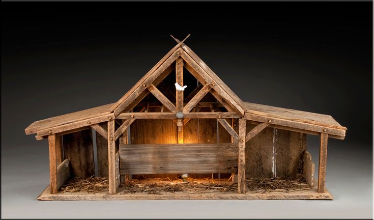 a nativity scene made out of wood, with a manger and crib