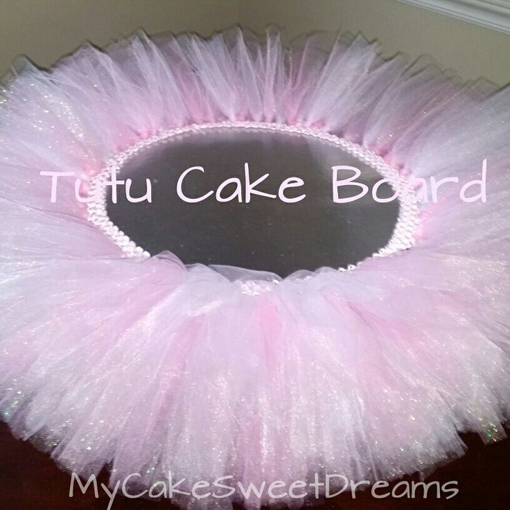 a pink tutu cake board sitting on top of a table