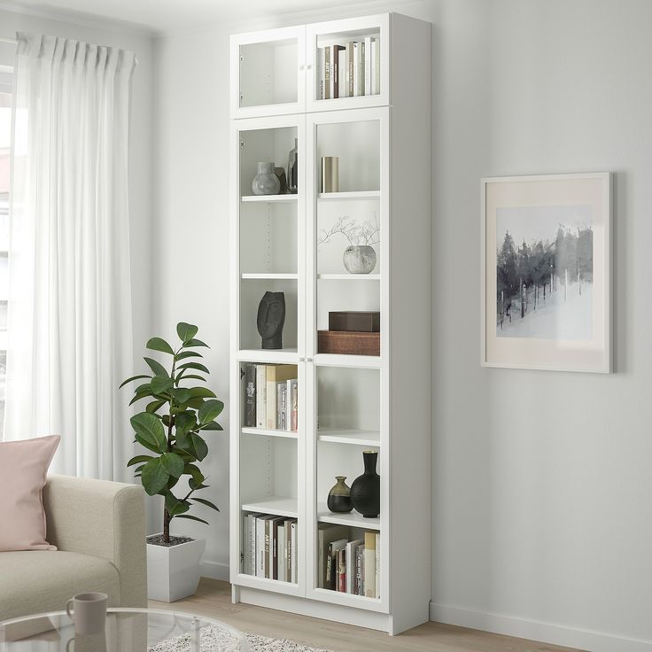 a living room filled with furniture and a white book shelf