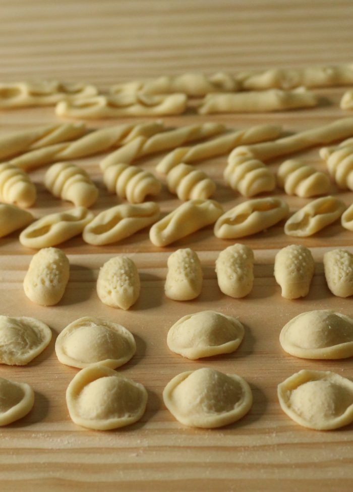 several different types of dough on a wooden surface