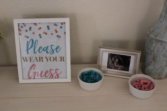 there are two small bowls and a sign on the table next to it, one is filled with beads