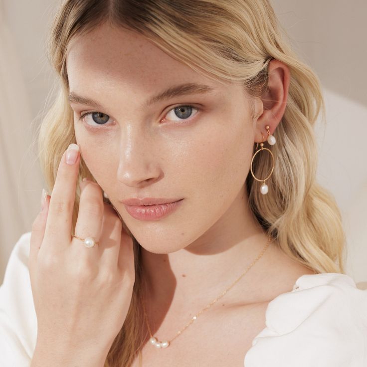 Answer the call of summer with these pearl favorites. We've taken a classic gold-plated hoop and turned it on its side for an unexpected twist. The fishhook rests gently in the lobe while the star of the earring — the freshwater pearls polished to perfection — adds movement and charm. Wear them on their own as statement makers, or stack them with our Pearl Studs to have a true mermaid moment. Summer Wedding Jewelry With Pearl Charm, Summer Wedding Pearl Charm Jewelry, Elegant Summer Pearl Earrings With Pearl Charm, Elegant Pearl Charm Earrings For Summer, Elegant Pearl Earrings With Pearl Charm For Summer, Elegant Gold Pearl Earrings For Summer, Elegant Everyday Summer Jewelry, Gold Pearl Drop Jewelry For Summer, Summer Dainty Pearl Chain Jewelry