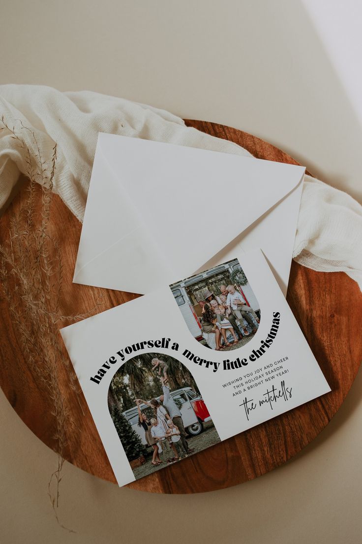 two envelopes and some white paper on a wooden board