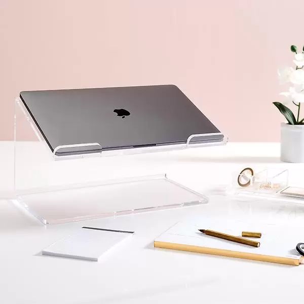 an apple laptop sitting on top of a desk next to some pens and pencils