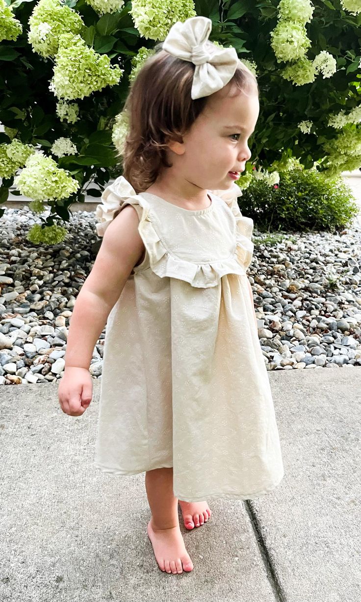 Sizes: 0-3 Month to 8 Years Skill level: IntermediateFormats: A4/Letter, A0, ProjectorFabric: lightweight woven Olena is a sleeveless dress with ruffles at the front extending over shoulders to back, a full button opening at the back, and a gathered seam above a flared skirt. The bodice is unlined with arm and neck openings finished with a single-fold bias tape. Designed to have a regular fit with moderate ease around the chest. Length falls an inch below the knee, the bottom hem is slightly rou Girl Dress Sewing Pattern, Girls Dress Sewing Patterns, Garment Pattern, Dress With Ruffles, Bias Tape, Dress Sewing Pattern, Photo Tutorial, Flared Skirt, Sewing Dresses