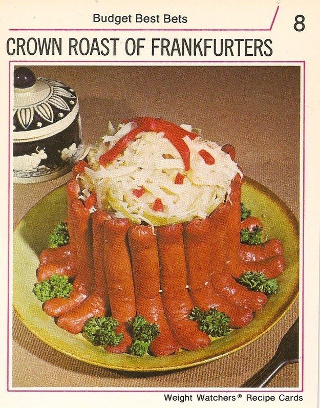 a plate topped with lots of hot dogs on top of broccoli and coleslaw