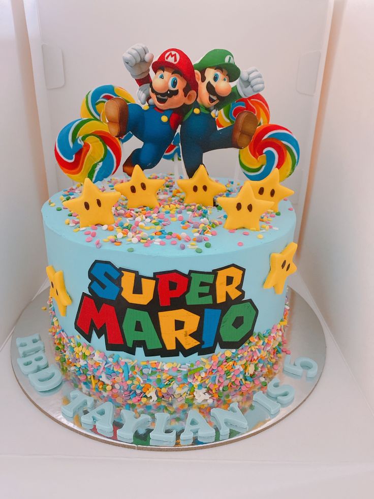 a birthday cake decorated with sprinkles and an image of mario on top