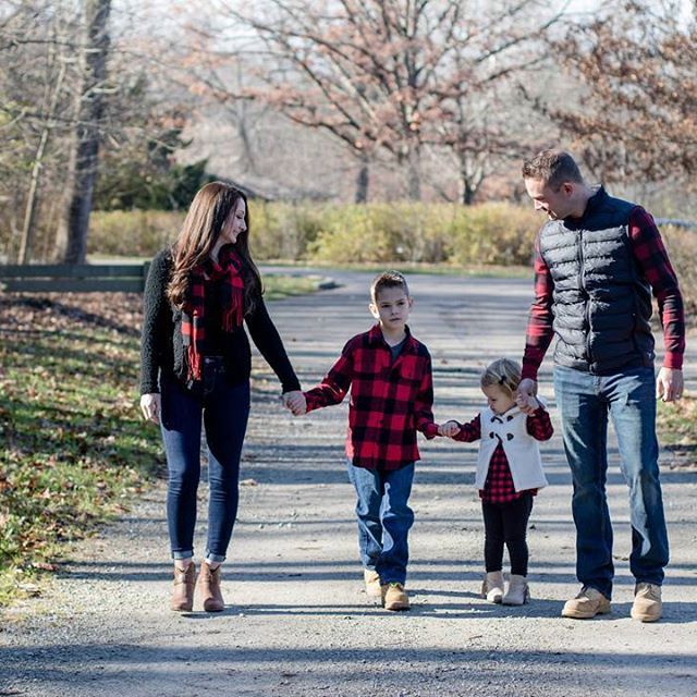 a family walking down the road holding hands