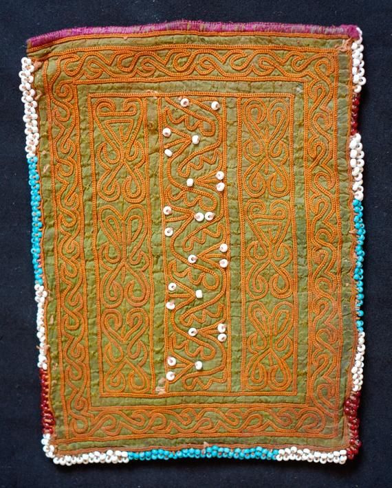 This is a beautiful Pashtun silk embroidered pouch in a wonderful green hue from the Paktia province, Afghanistan.  It is surrounded by blue glass beads.  The workmanship is of very high quality and hand done.  -Natural colors-High quality workmanship Green Embroidered Fabric For Ceremonial Occasions, Ceremonial Green Embroidered Fabric With Intricate Designs, Traditional Green Beaded Bag, Ceremonial Green Embroidered Fabric, Ceremonial Green Intricate Embroidered Fabric, Traditional Green Beaded Bags, Embroidered Pouch, Face Photo, Silk Embroidery