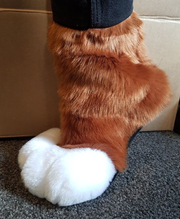 a close up of a stuffed animal's leg with fur on the top and bottom