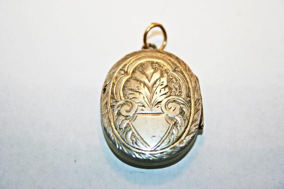 Antique Victorian silver locket, circa 1890s. In good condition, with minor wear and dings commensurate to age; along one edge of the cross, there is a hairline gap in the engraving, where the instrument used to emboss the locket's surface split through the metal. See photos for condition and measurements. Antique Engraved White Gold Locket Necklace, Vintage White Gold Medallion Locket Necklace, Antique Silver Hallmarked Locket Necklace, Antique Etched Locket Necklace For Memorial, Antique Sterling Silver Locket Necklace, Silver Victorian Locket Necklace For Memorial, Antique Silver Engraved Locket Necklace For Memorial, Antique White Gold Locket Necklace, Engraved Antique Silver Locket Necklace For Memorial