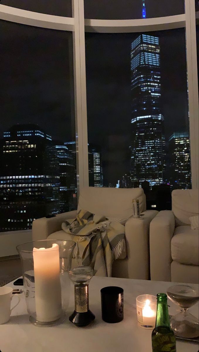 a living room filled with furniture and candles