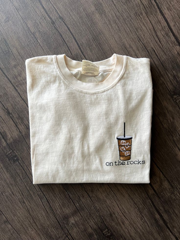 This one’s for the gals that love their iced coffee! This fun iced coffee design is embroidered on an ivory Comfort Colors T-Shirt. 100% Ring Spun Cotton Relaxed Fit Preshrunk, soft washed, garment dyed fabric Made with sustainably and fairly grown USA cotton and sewn with USA cotton thread Double-needle stitched sleeves and bottom hem Larger sizes available on request! Iced Coffee Shirt, Coffee Shirt, Toddler Halloween, On The Rocks, Coffee Design, Coffee Shirts, Embroidered Tshirt, Dyed Fabric, Cotton Thread