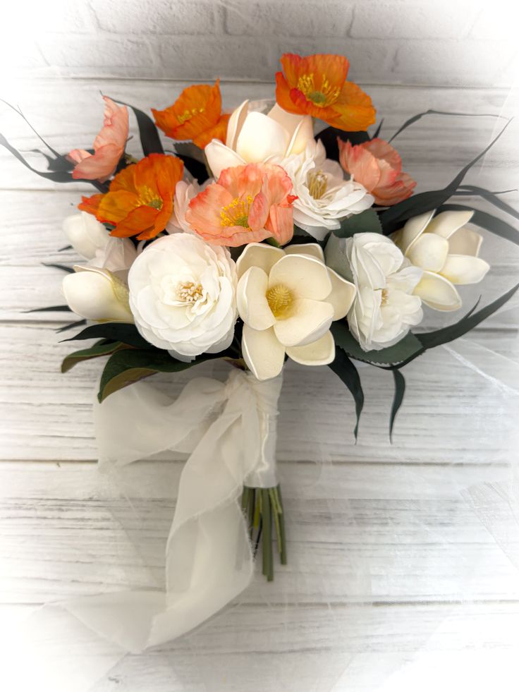 a bouquet of white and orange flowers