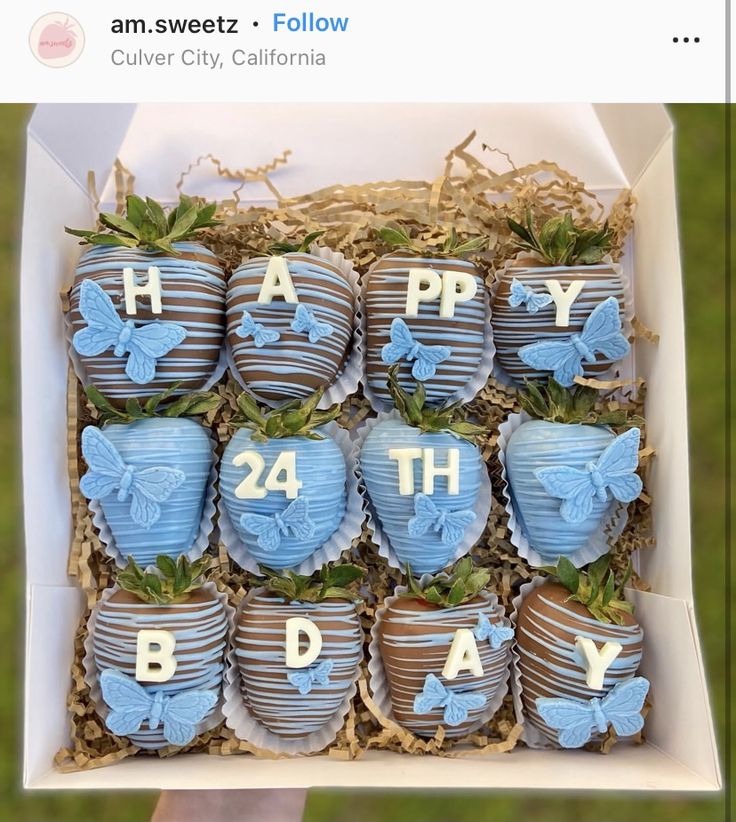 a box filled with chocolate covered strawberries in the shape of hearts and butterflies on top of each other