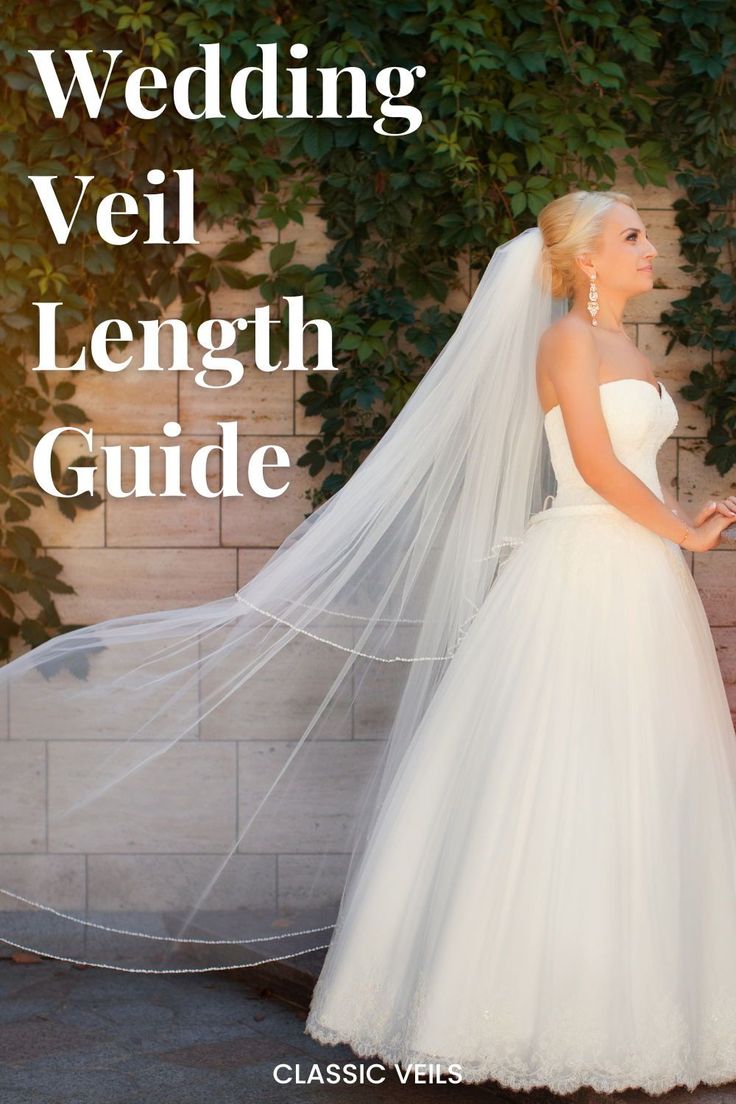 a woman in a wedding dress and veil standing next to a brick wall with vines