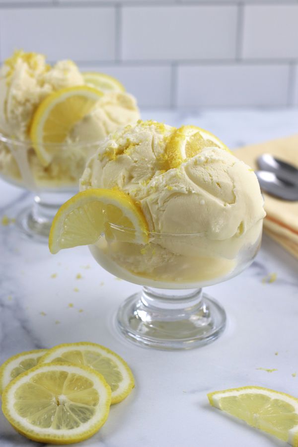 two glasses filled with ice cream and lemon slices