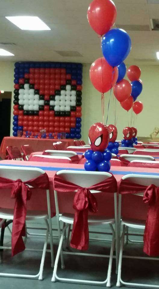 spiderman balloon centerpieces and table decorations at a birthday party with balloons in the shape of characters