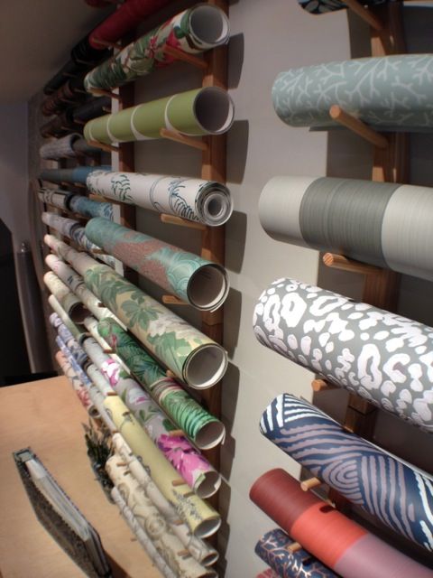 the wall is full of rolled up fabric